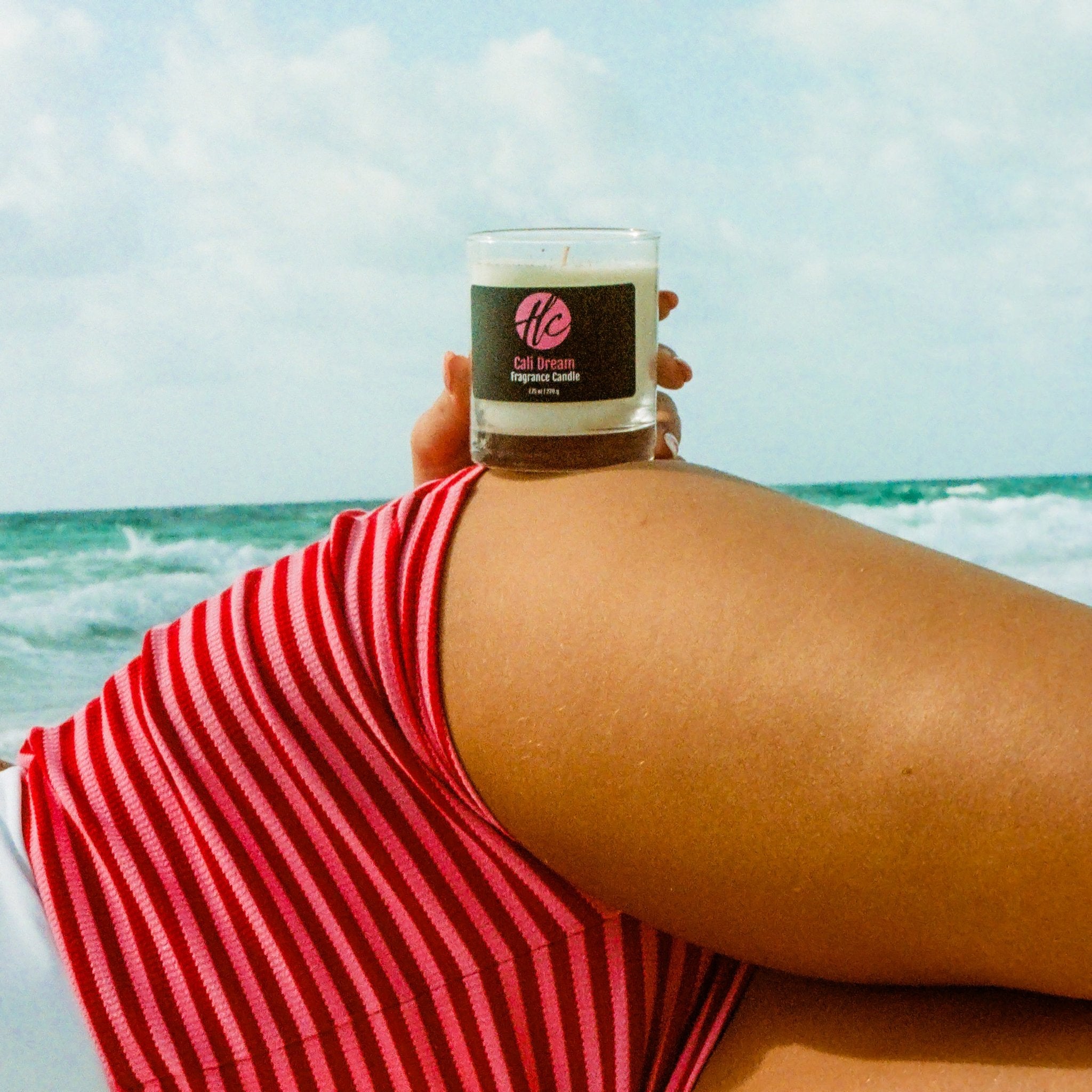 Halcyon Coast Cali Dream non-toxic fragrance candle held at the beach, capturing carefree California summer vibes.